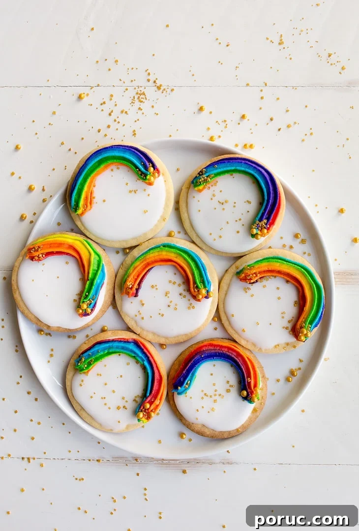 Rainbow Cookies with rainbow swirl buttercream frosting and a white Royal Icing base