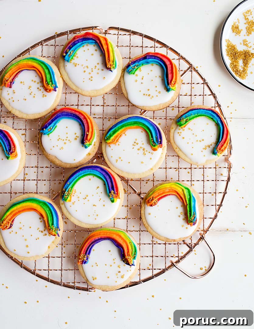 Rainbow Cookies with rainbow swirl buttercream frosting and a white Royal Icing base