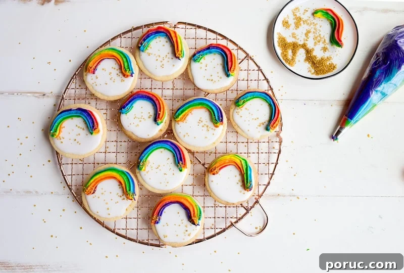 Rainbow Cookies with rainbow swirl buttercream frosting and a white Royal Icing base