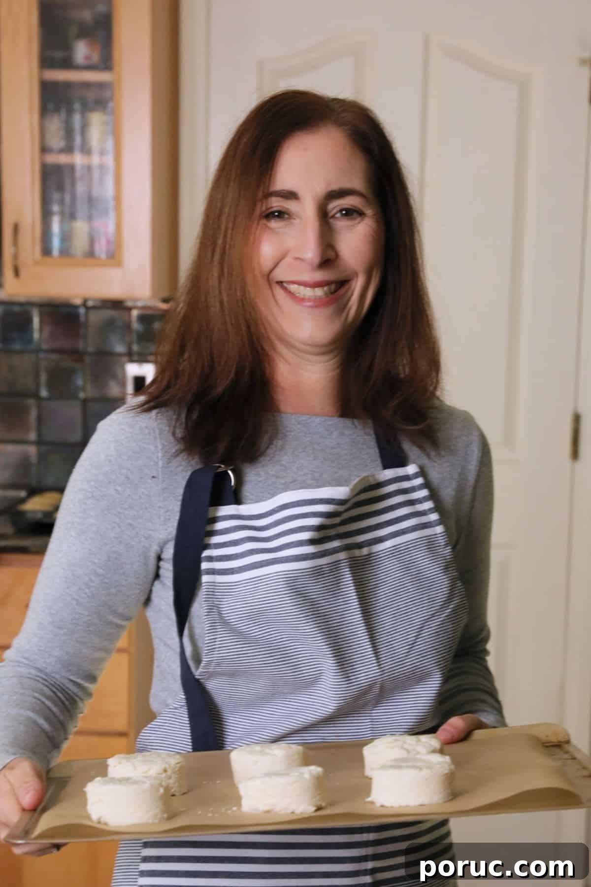 Gluten-Free Zucchini Muffins Kids Love — Dairy-Free Recipe 4 Sandi holding a tray of biscuits that are going in the oven to bake.