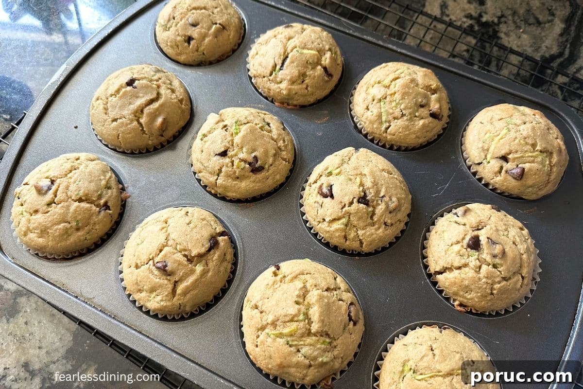 Gluten-Free Zucchini Muffins Kids Love — Dairy-Free Recipe 10 Baked muffins in the pan on the kitchen counter.