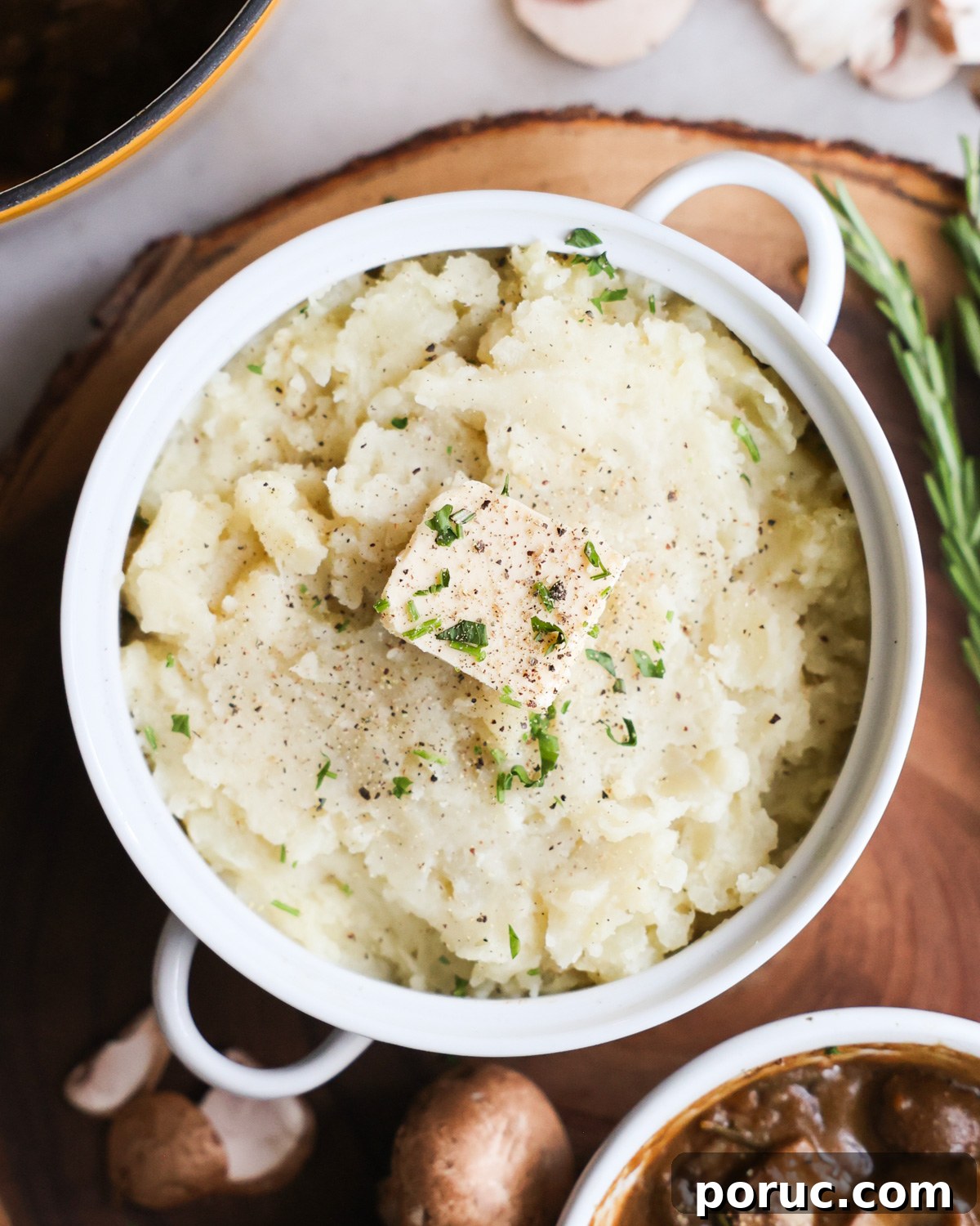 Fluffy Vegan Mashed Potatoes Recipe for Creamy Comfort 2 overhead of a serving bowl of vegan mashed potatoes with mushroom gravy.