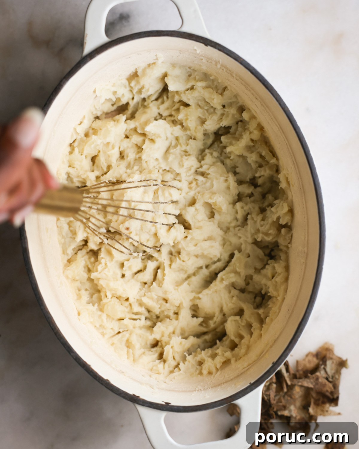 Fluffy Vegan Mashed Potatoes Recipe for Creamy Comfort 11 overhead of a whisk mashing vegan mashed potatoes