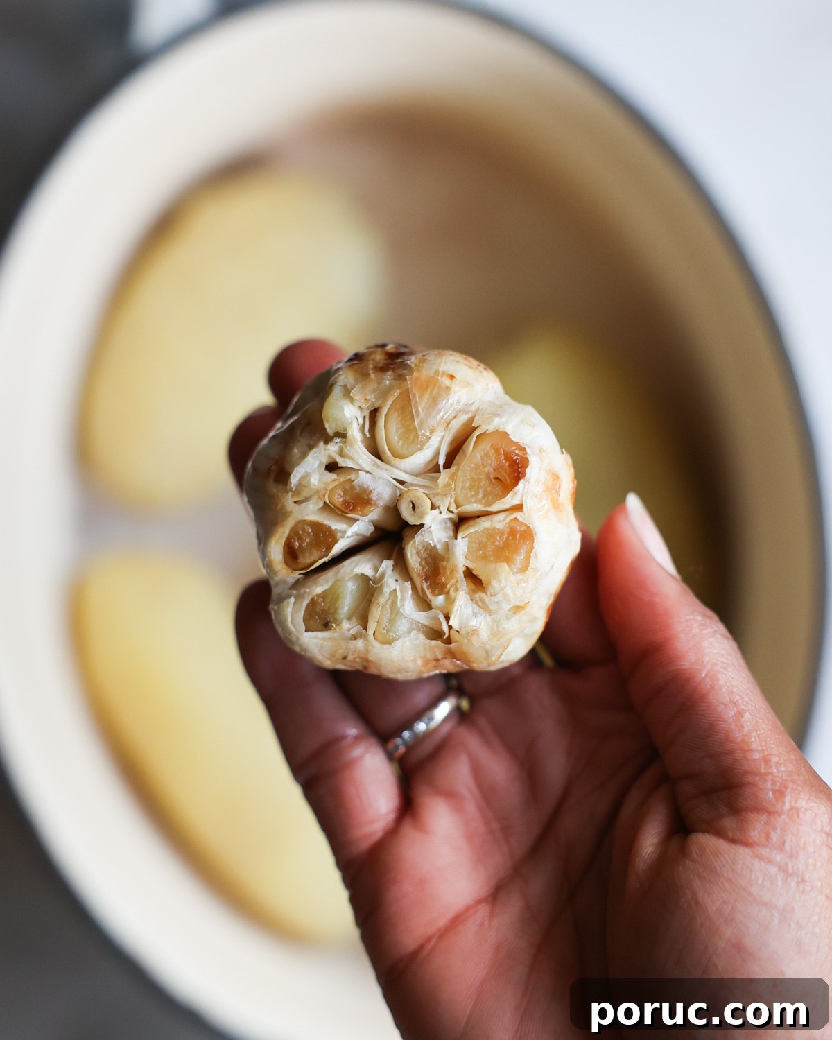 Fluffy Vegan Mashed Potatoes Recipe for Creamy Comfort 4 tender roasted garlic in Jenné's hand