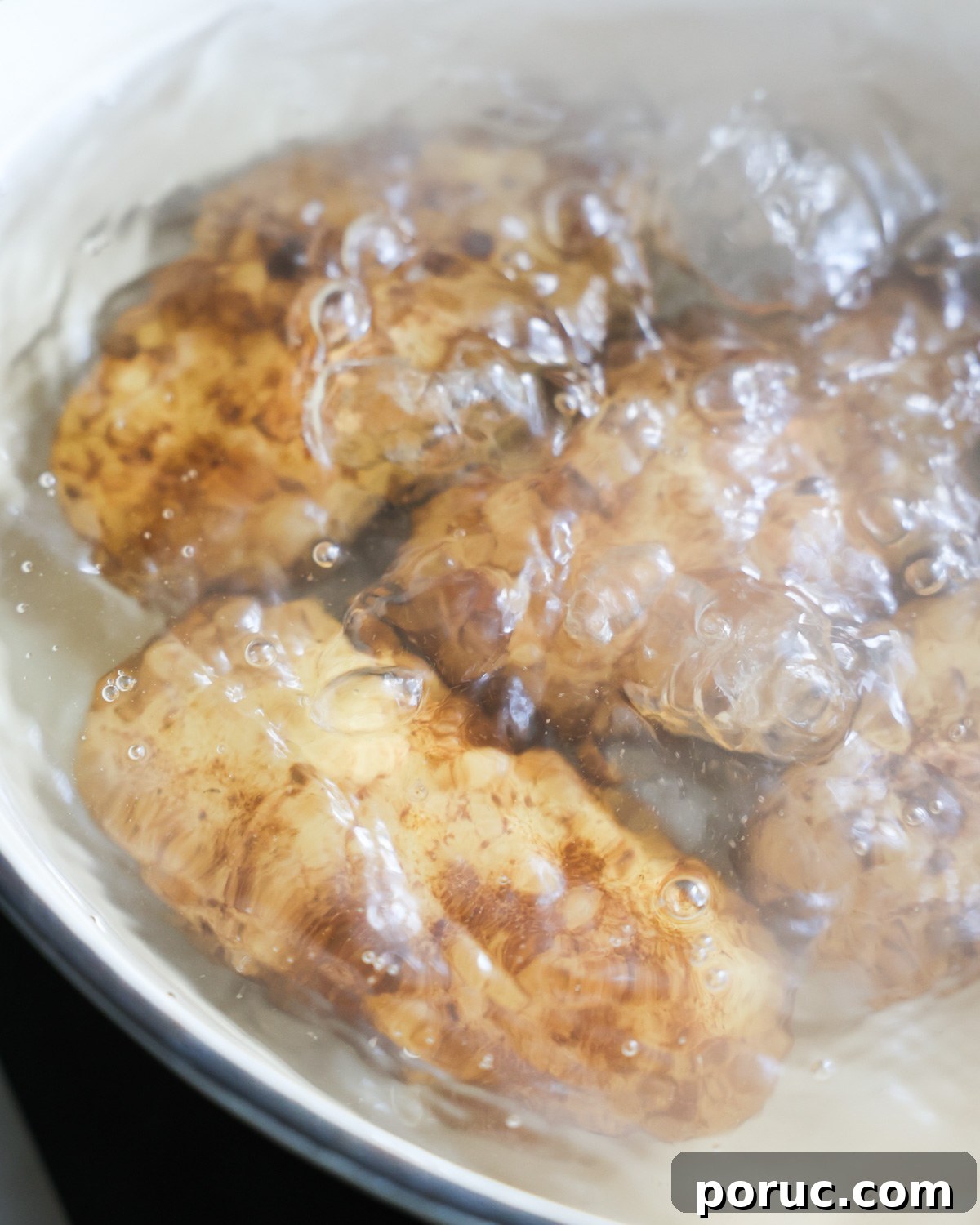 Fluffy Vegan Mashed Potatoes Recipe for Creamy Comfort 6 close up of potatoes boiling in a pot