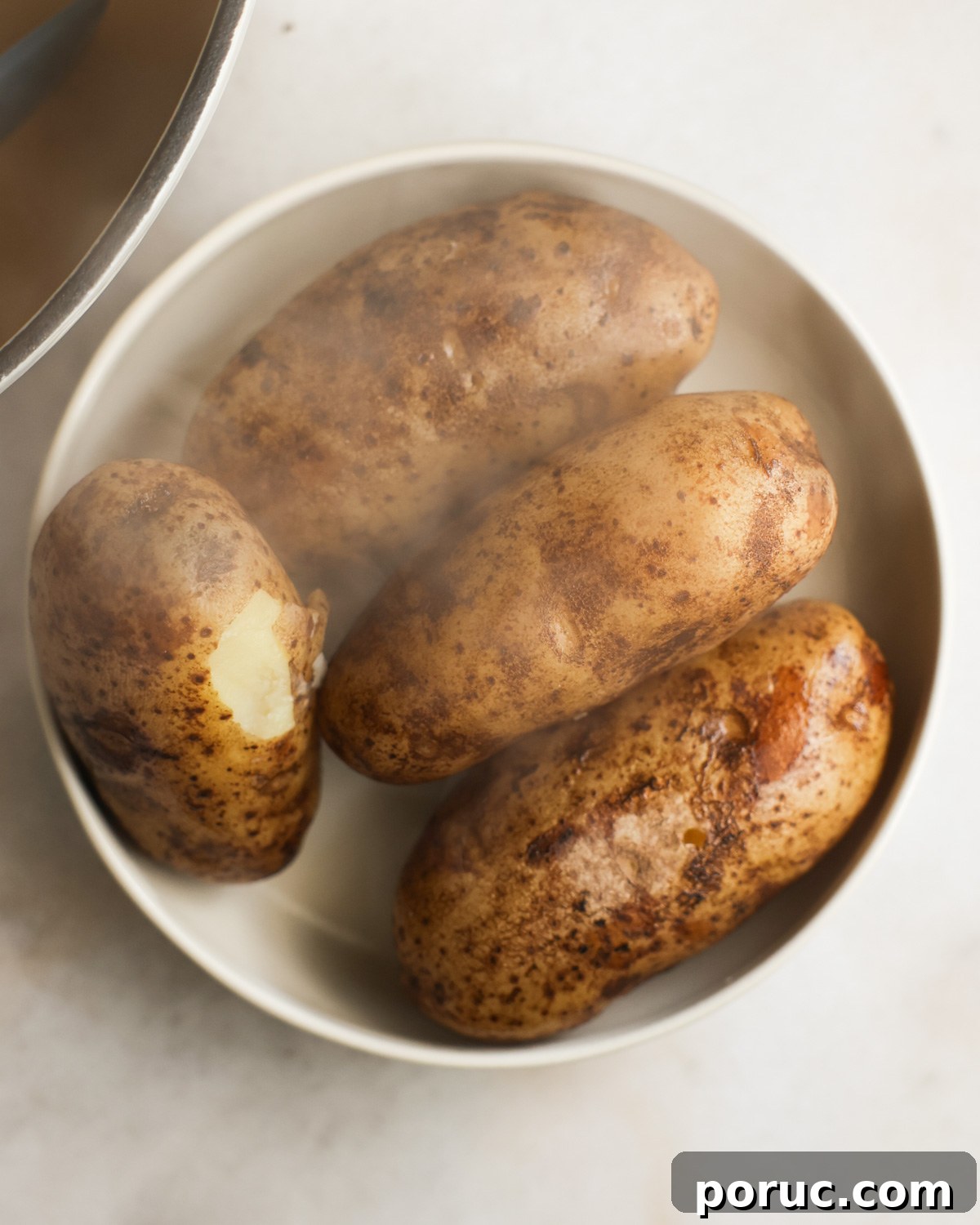 Fluffy Vegan Mashed Potatoes Recipe for Creamy Comfort 7 overhead of cooked potatoes cooling in a dish