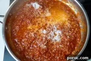 Creamy Tomato Pasta Without Dairy: Rich Vegan Tomato Pasta Recipe 14 Adding pasta water and cheese to the pan