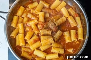 Creamy Tomato Pasta Without Dairy: Rich Vegan Tomato Pasta Recipe 16 Stirring in the pasta