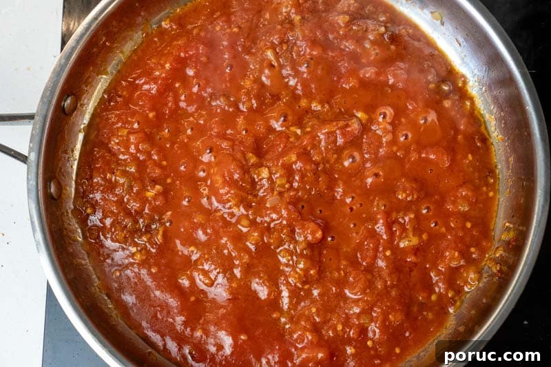 Creamy Tomato Pasta Without Dairy: Rich Vegan Tomato Pasta Recipe 6 Adding the crushed tomatoes