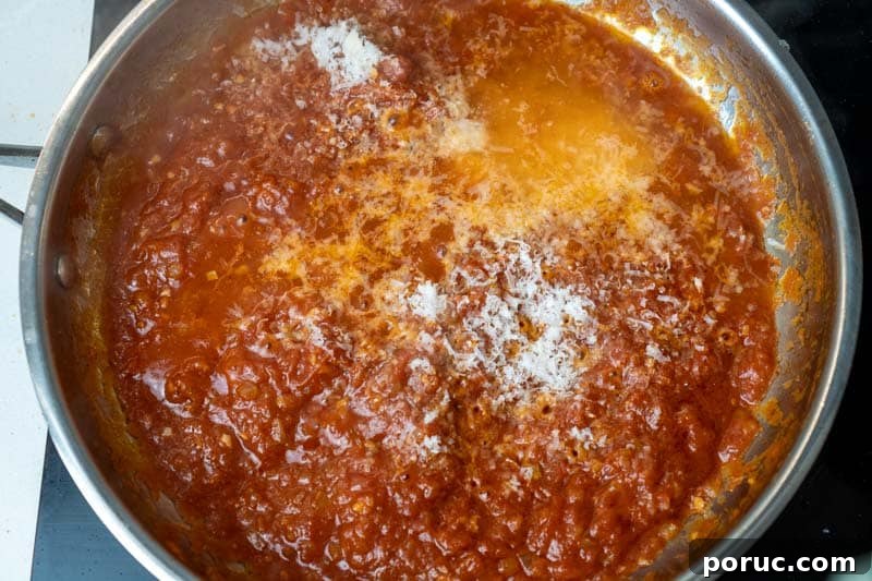 Creamy Tomato Pasta Without Dairy: Rich Vegan Tomato Pasta Recipe 7 Adding pasta water and cheese to the pan