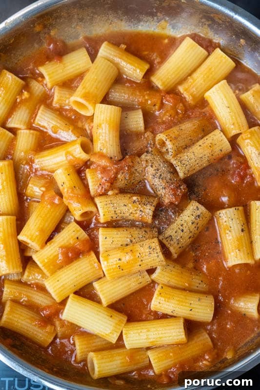 Creamy Tomato Pasta Without Dairy: Rich Vegan Tomato Pasta Recipe 8 Stirring in the pasta