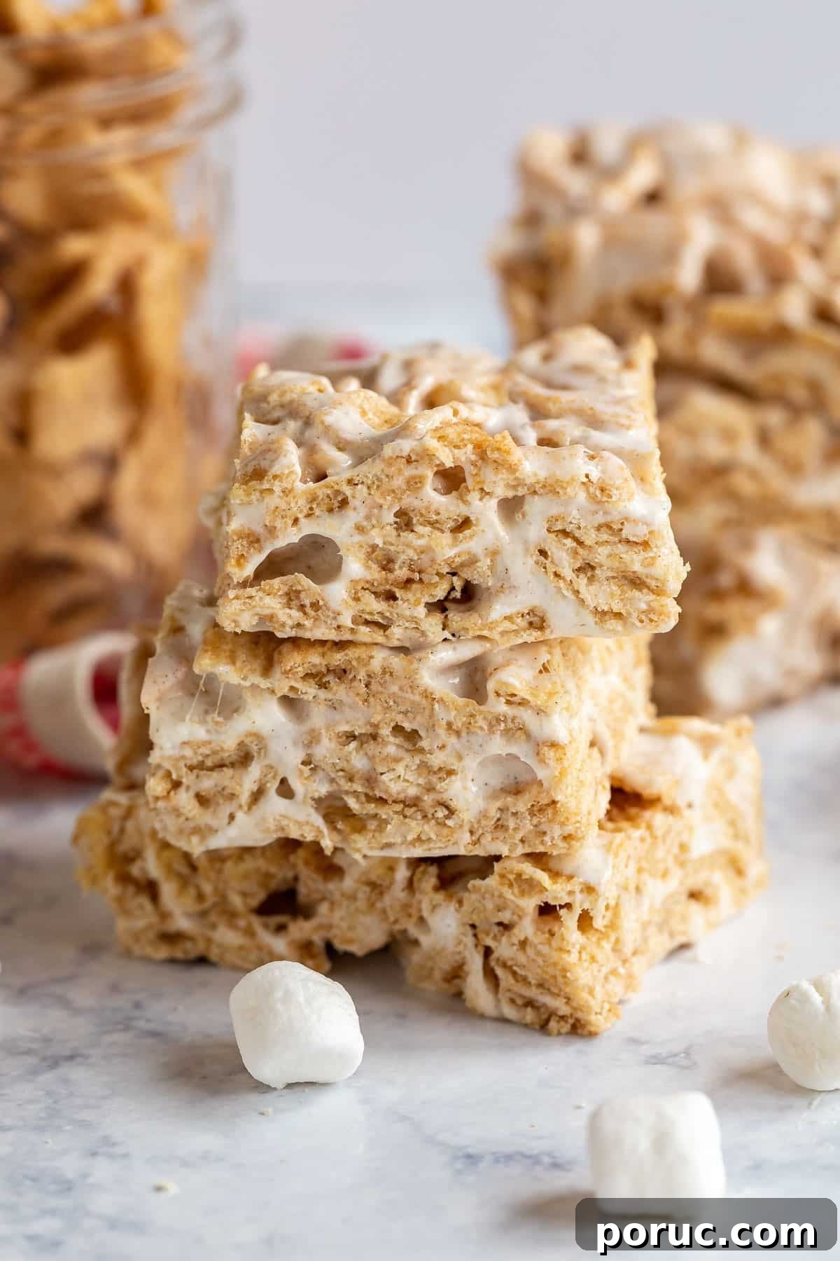 Homemade Cinnamon Toast Crunch Treat Bars Recipe 2 A straight on image of 3 cinnamon cereal bars stacked on each other exposing the inside of the bars.