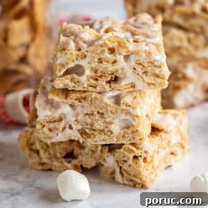 Homemade Cinnamon Toast Crunch Treat Bars Recipe 15 A straight on image of 3 cinnamon cereal bars stacked on each other exposing the inside of the bars.