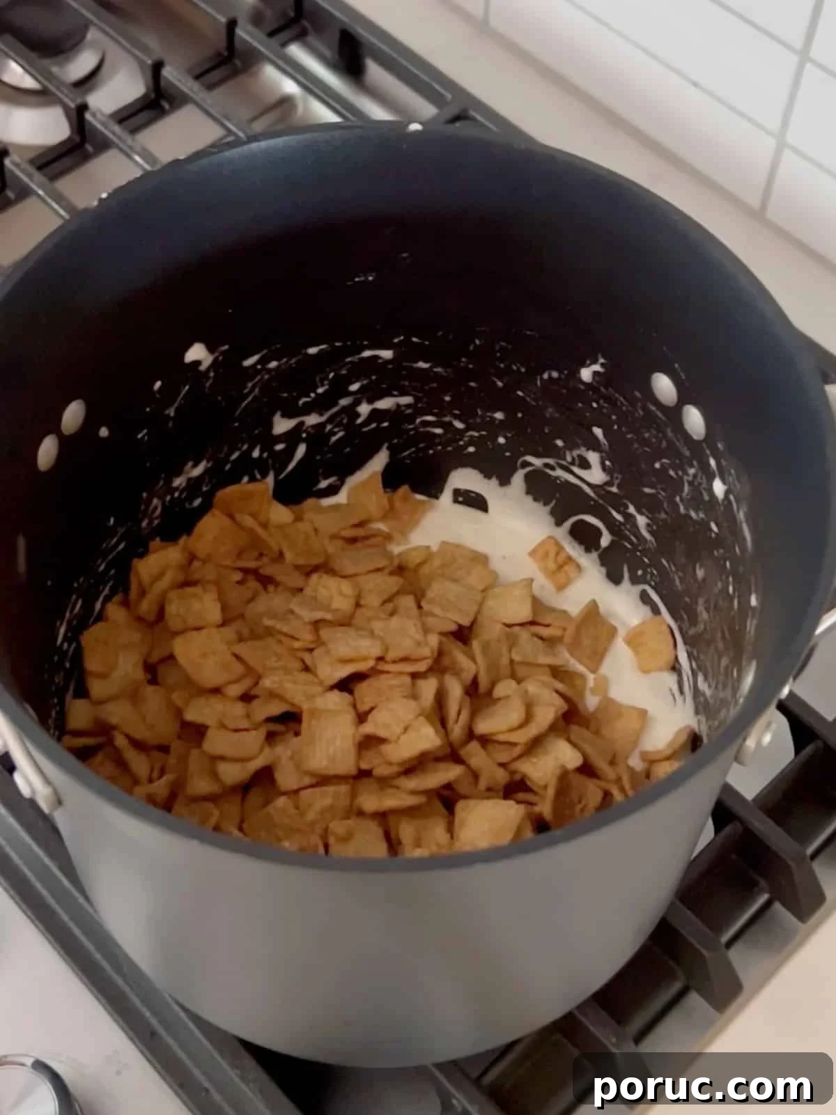 Homemade Cinnamon Toast Crunch Treat Bars Recipe 7 Cereal added to the pot of melted marshmallows.