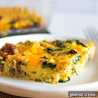 sausage egg casserole slice on a white plate.