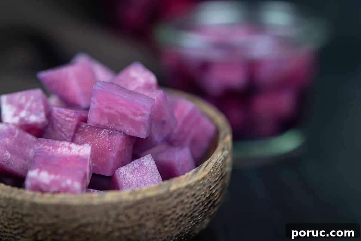A bowl filled with cubed purple blueberry pickled radishes.