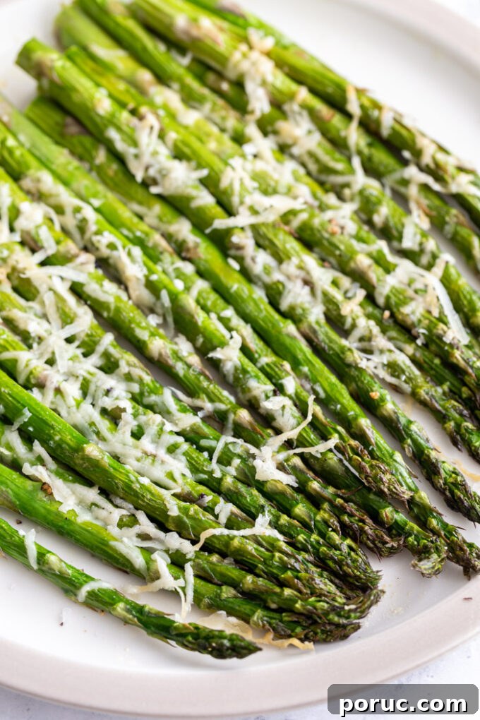 Crispy Air Fryer Asparagus Recipe — Quick Weeknight Side 6 air fryer asparagus topped with parmesan cheese