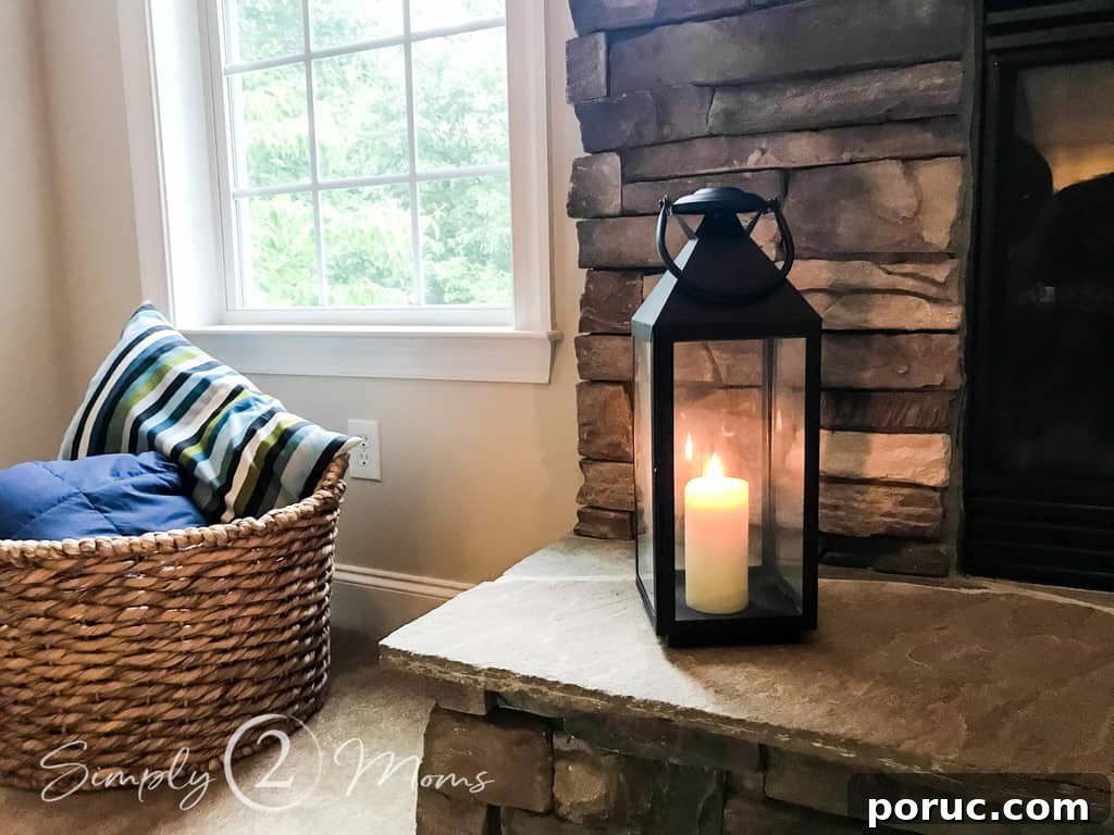  close up of black lantern on hearth with basket of blankets
