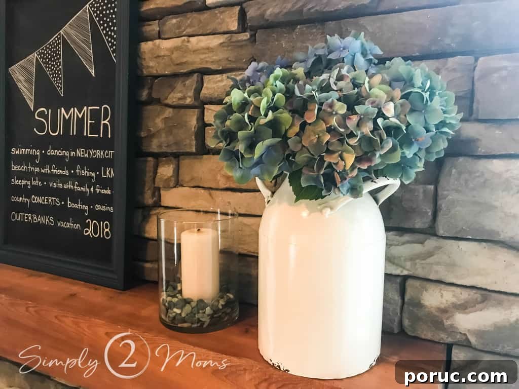 close up of white jug with hydrangea on fireplace mantle