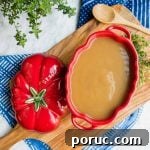 Turkey Au Jus Recipe — Savory Thin Gravy for Roast Turkey 5 Turkey Au Jus Gravy in staub tureen flatlay.
