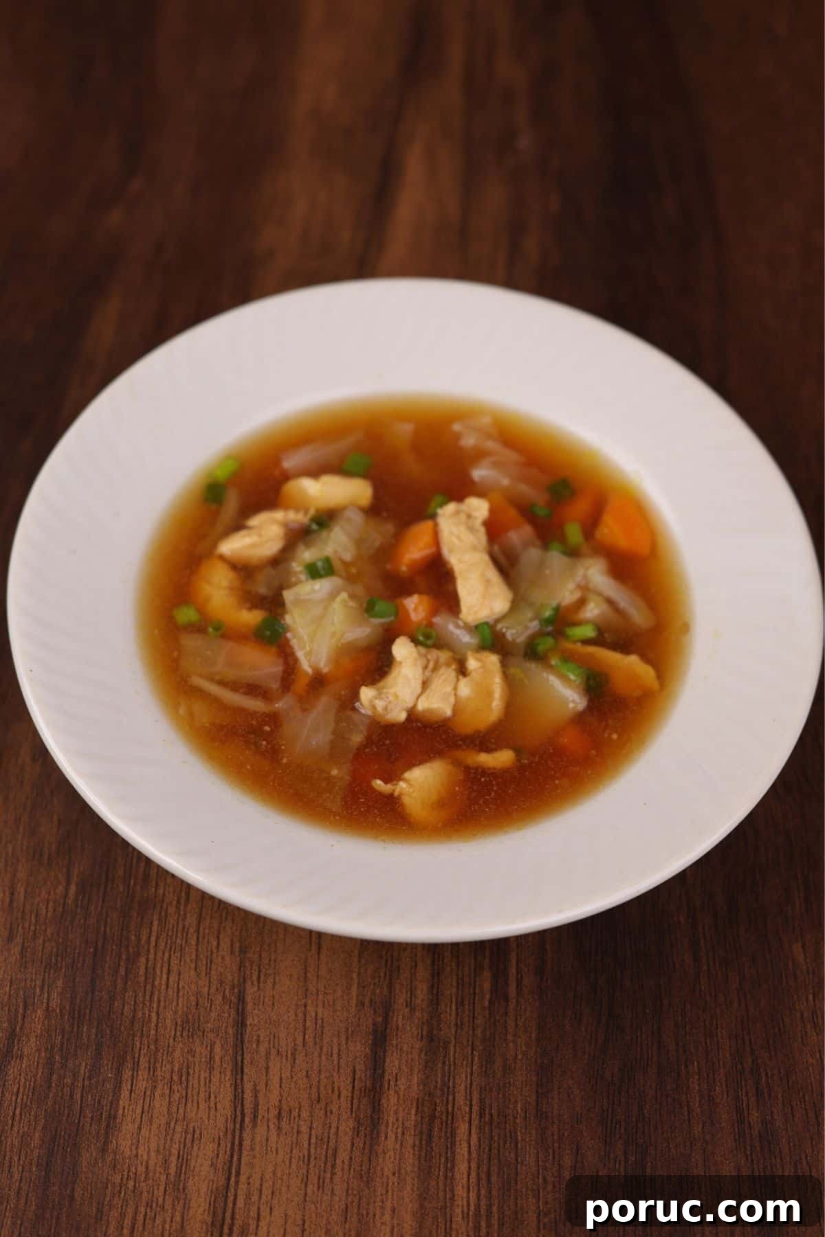 Asian-Style Chicken and Napa Cabbage Soup Recipe 6 Chicken cabbage soup served in a white bowl.