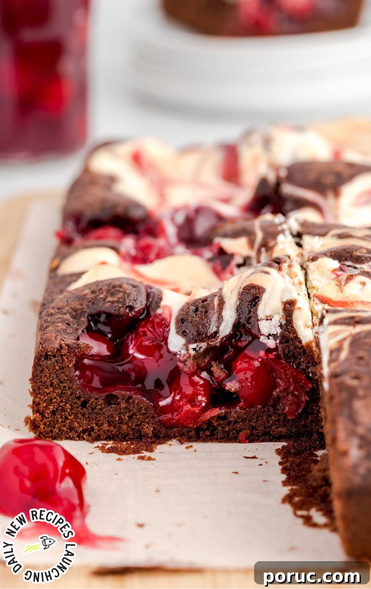 close up shot of Cherry Cheesecake Brownie on a wooden board