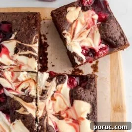 close up overhead shot of Cherry Cheesecake Brownie on a wooden board