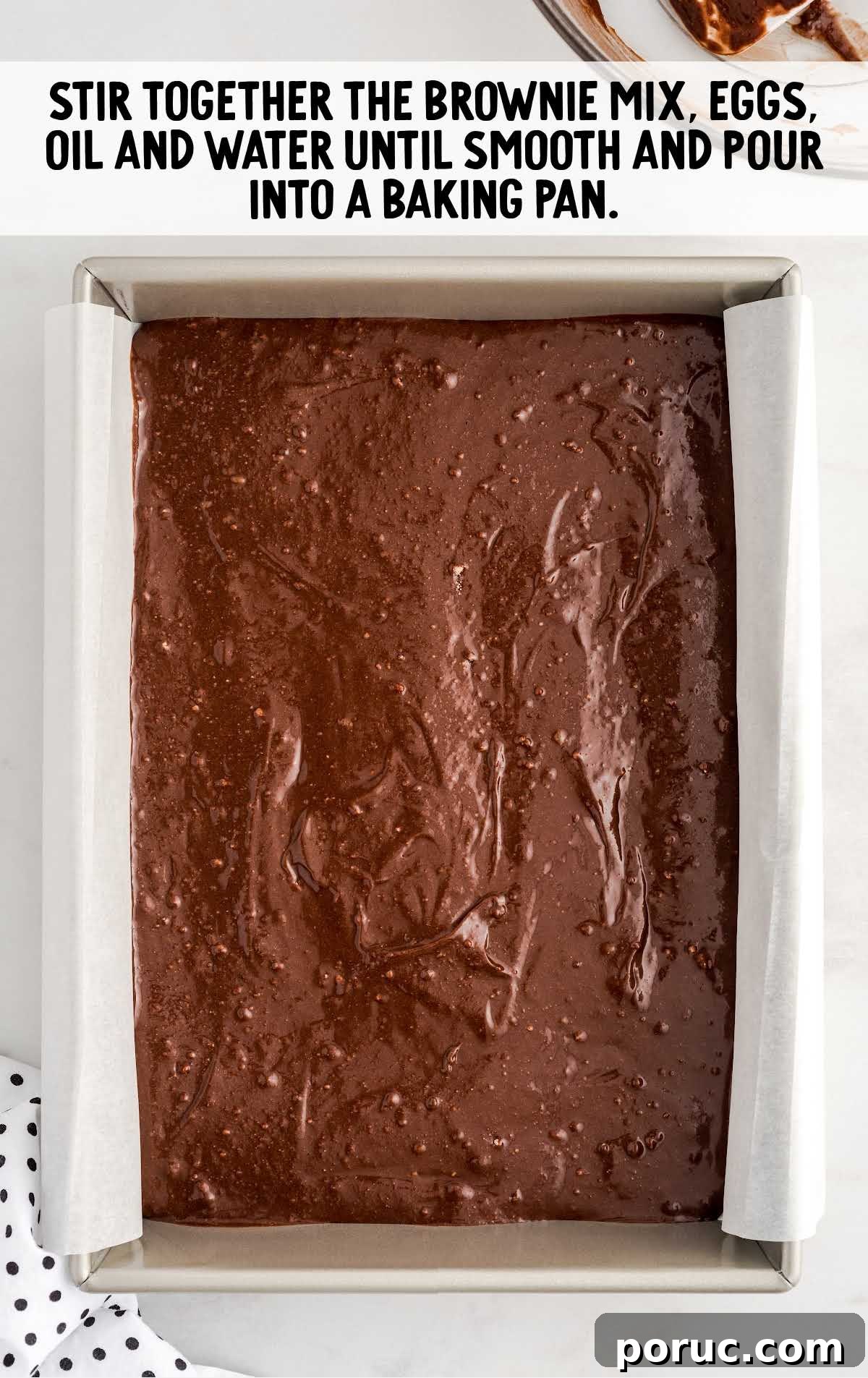 brownie mixture, eggs, oil, and water poured into a baking pan