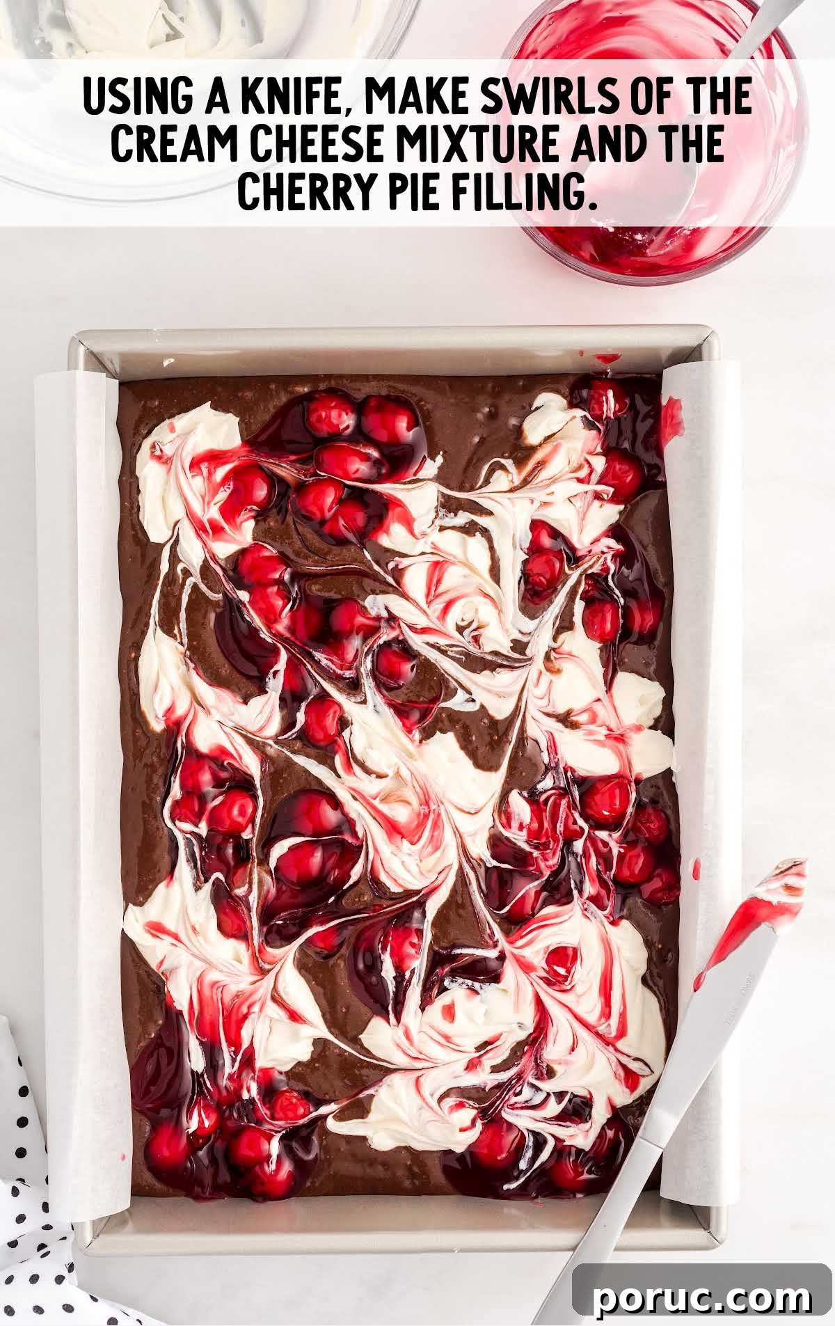 swirls made on top of the brownie mixture with the cream cheese mixture and the cherry pie filling