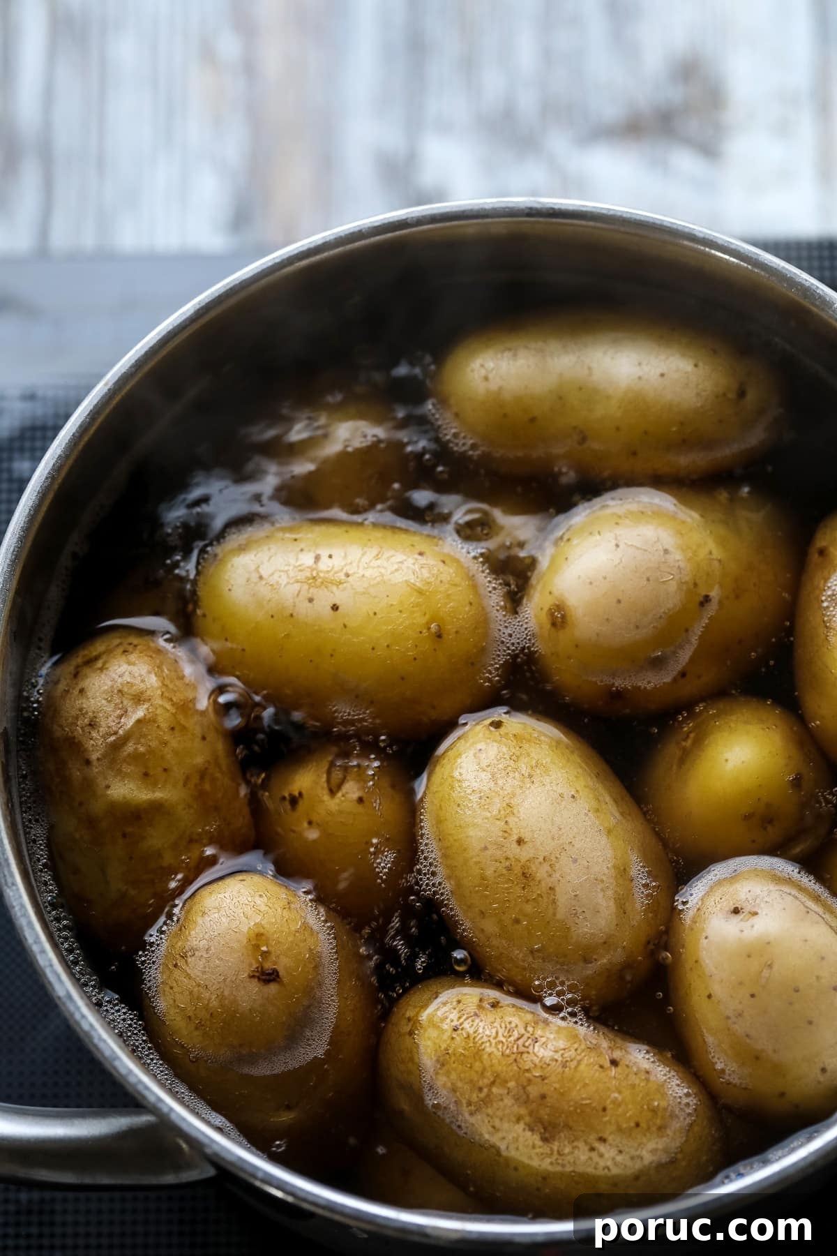 Potatoes boiling in a pot.