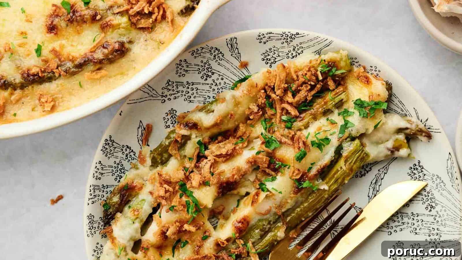 29 Air Fryer Casseroles Perfect for Busy Weeknight Dinners 24 Cheesy asparagus casserole on a plate with a fork.