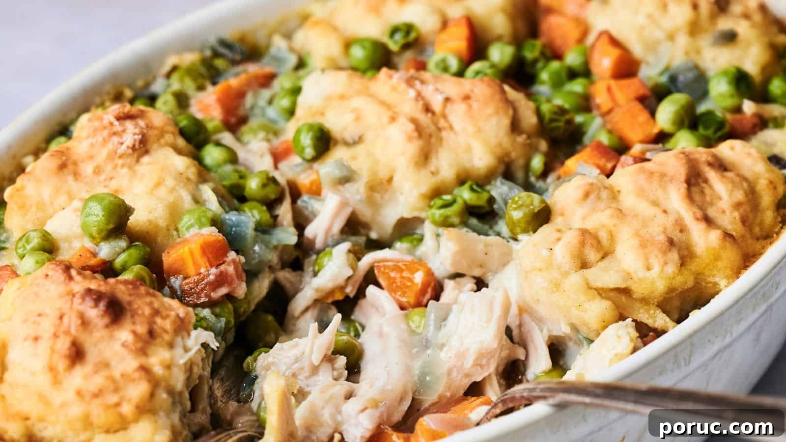 29 Air Fryer Casseroles Perfect for Busy Weeknight Dinners 25 Air Fryer Chicken and Dumpling Casserole with baked dumplings, tender pieces of chicken, fresh peas, carrots, and a creamy sauce.