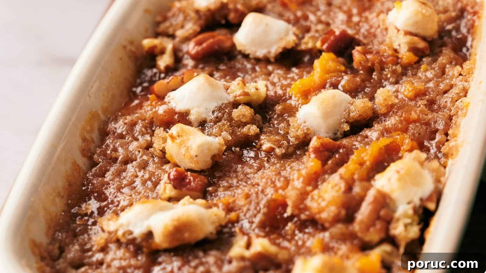 29 Air Fryer Casseroles Perfect for Busy Weeknight Dinners 31 A white dish with a sweet potato casserole on top of a wooden cutting board.