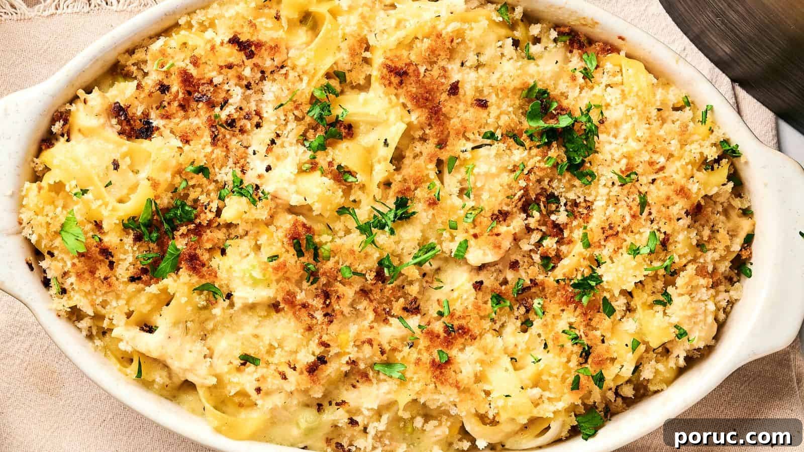 29 Air Fryer Casseroles Perfect for Busy Weeknight Dinners 6 Baked pasta in a white dish, topped with golden breadcrumbs and garnished with parsley.