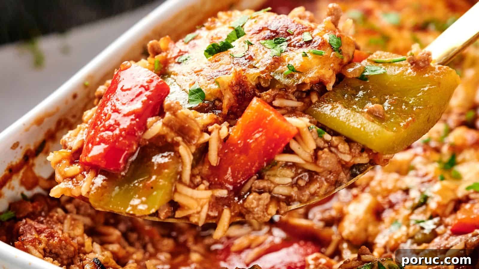 29 Air Fryer Casseroles Perfect for Busy Weeknight Dinners 8 A spoonful of baked stuffed pepper casserole with ground meat, rice, and diced red and green bell peppers, garnished with parsley.