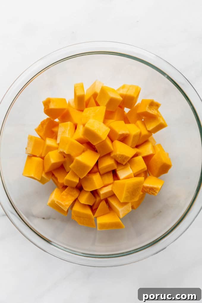 Roasted Pumpkin Salad with Maple Vinaigrette and Toasted Seeds 4 cubes of pumpkin in a clear mixing bowl
