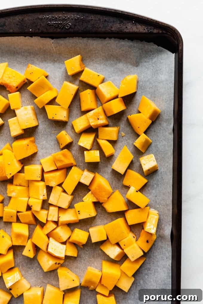 Roasted Pumpkin Salad with Maple Vinaigrette and Toasted Seeds 6 cubes of uncooked pumpkin on a baking sheet