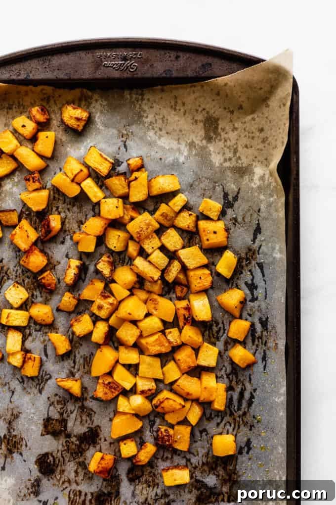 Roasted Pumpkin Salad with Maple Vinaigrette and Toasted Seeds 7 roasted pumpkin cut into cubes on a baking sheet