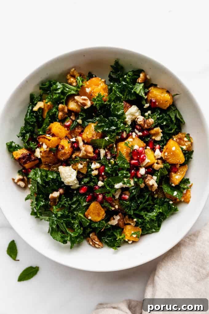 Roasted Pumpkin Salad with Maple Vinaigrette and Toasted Seeds 10 A white bowl with roasted pumpkin salad in it and a beige napkin on the side