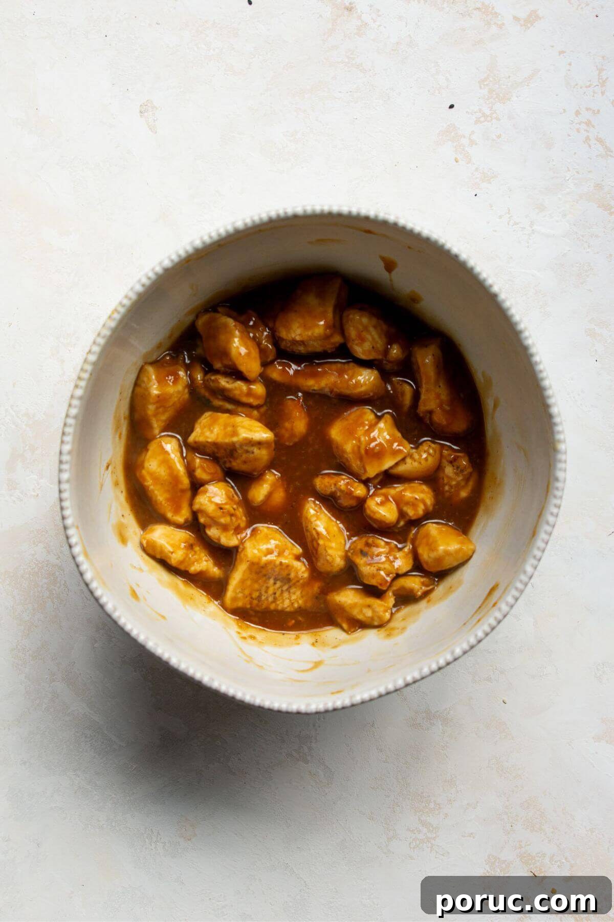 Crispy Air Fryer Orange Chicken Recipe You’ll Love 11 Crispy chicken pieces in a bowl tossed with the healthy orange sauce.