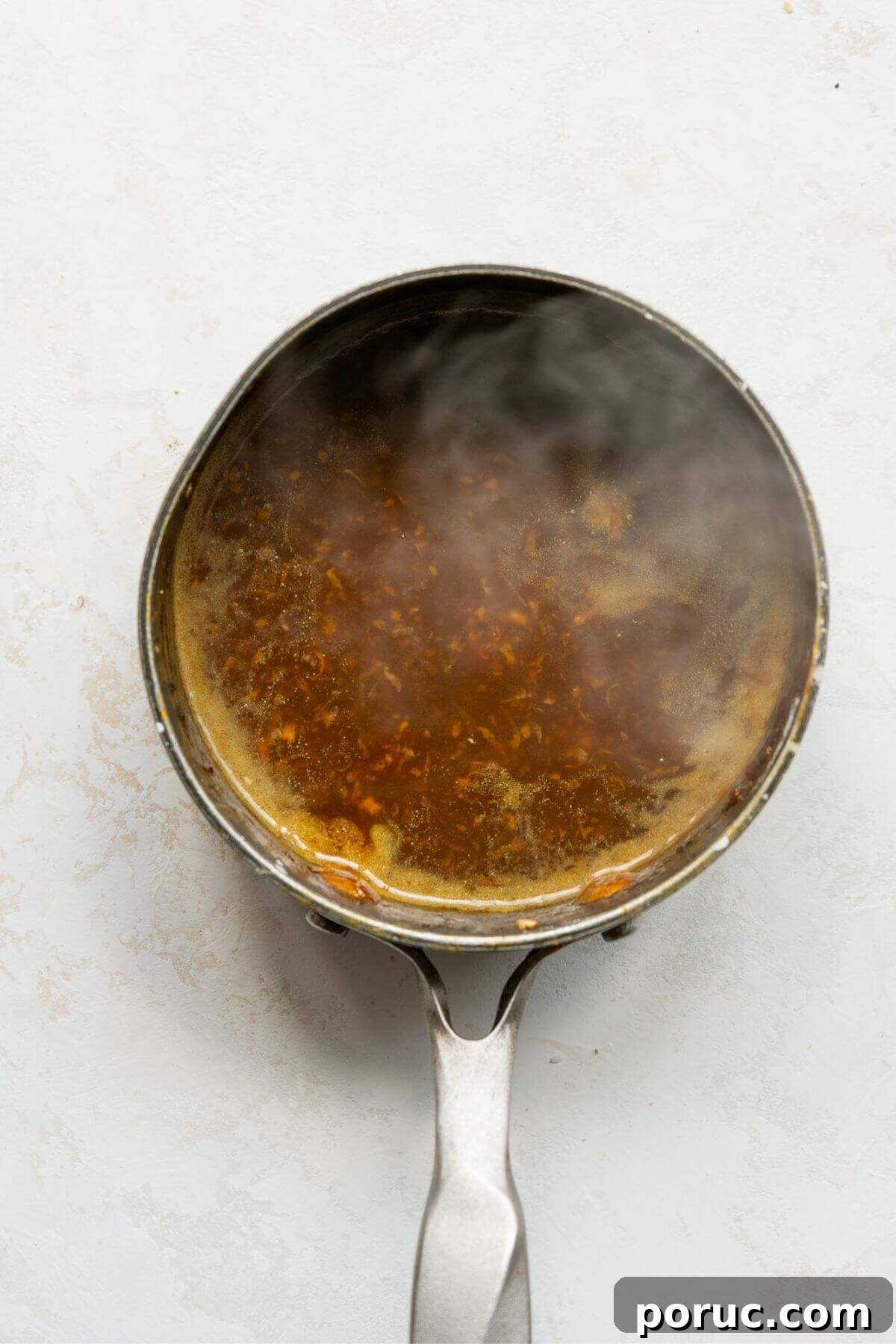 Crispy Air Fryer Orange Chicken Recipe You’ll Love 10 Healthy homemade orange sauce in a pot after simmering to thicken