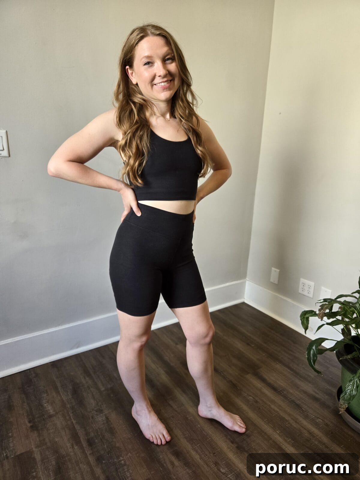 A woman wearing Pact black ribbed active set.