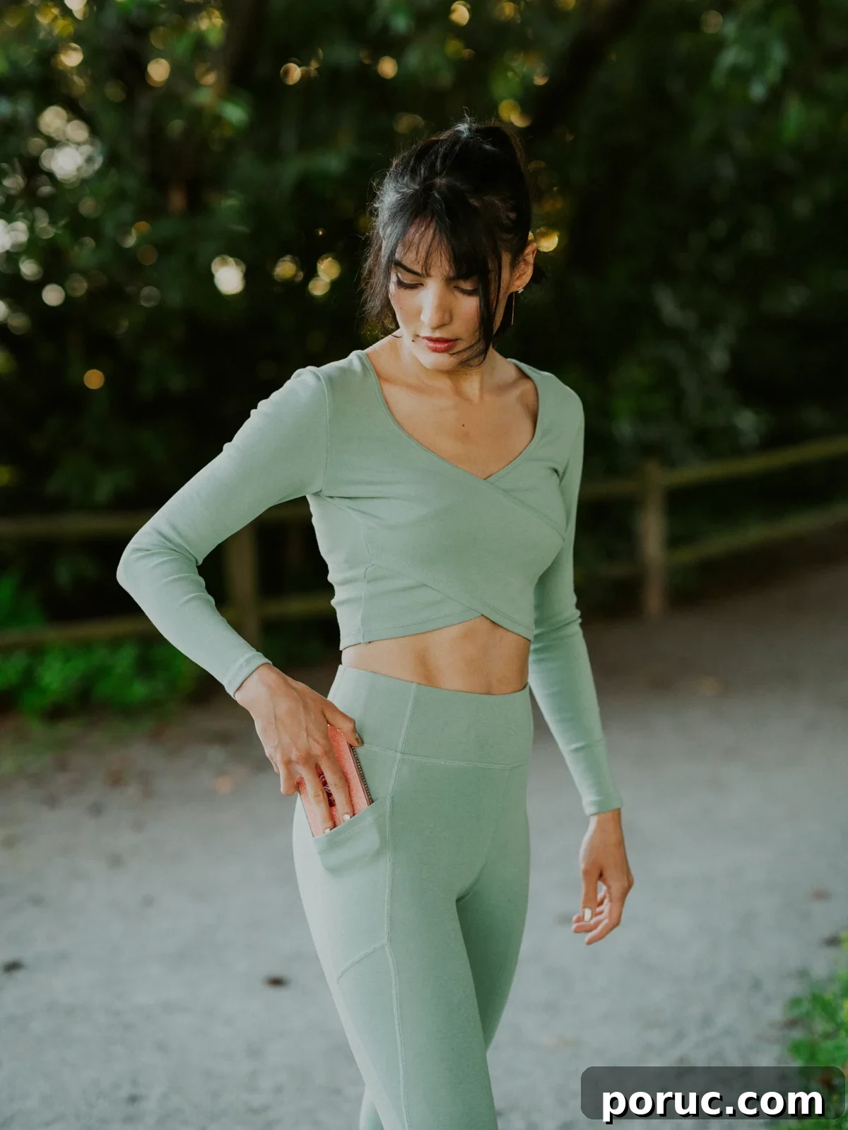 A woman wearing Happy Earth leggings with a side pocket.