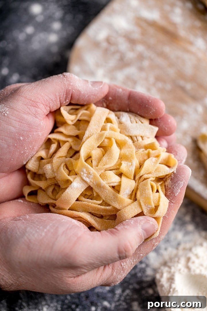 Homemade tagliatelle cupped in two hands