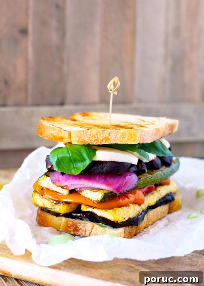 Grilled Vegetable Sandwich with Fresh Mozzarella & Basil Aioli 2 A sandwich stacked with sliced eggplant, yellow squash, bell peppers, zucchini, red onions, portobello mushrooms, mozzarella and basil.