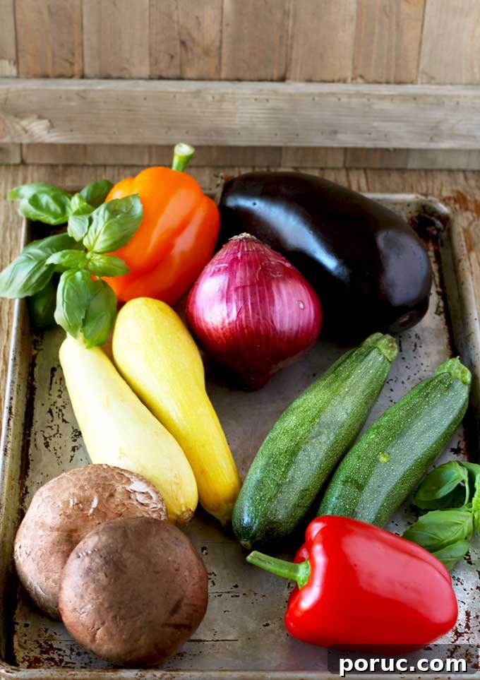 Grilled Vegetable Sandwich with Fresh Mozzarella & Basil Aioli 3 One eggplant, two yellow squash, one bell peppers, two zucchinis, one red onion and two portobello mushrooms in a baking sheet.