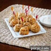 sausage balls on a plate with dip on the side