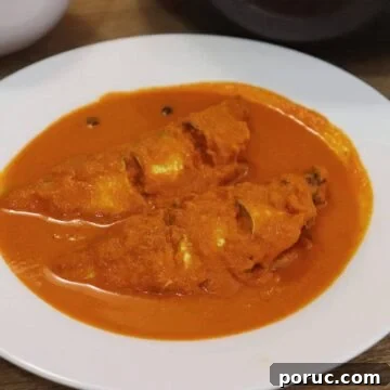 goan fish curry with coconut served in a white bowl.