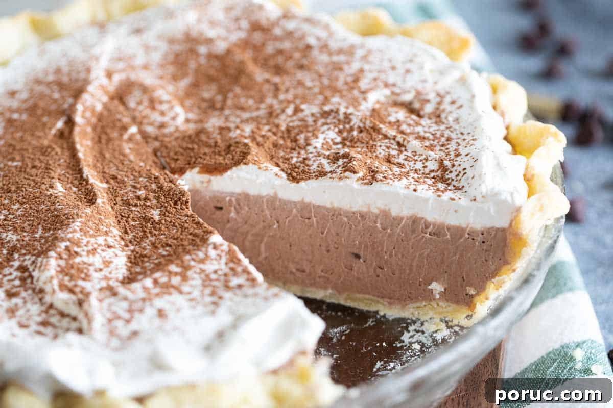 Rich, creamy and silky, this Chocolate Cream Pie is a chocolate lovers dream! A creamy chocolate filling is topped with whipped cream in this easy, crowd pleasing pie. chocolate cream pie with slice out of full pie