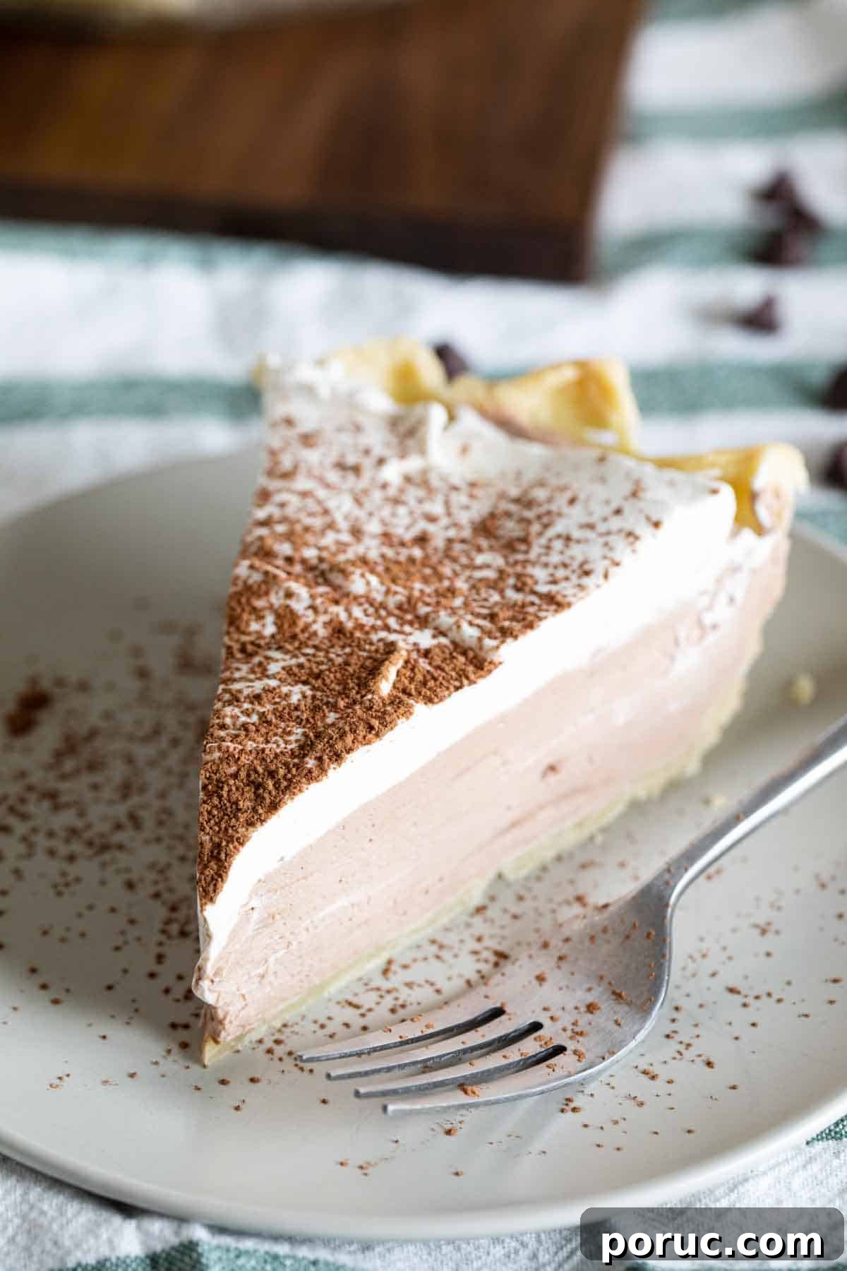 Rich, creamy and silky, this Chocolate Cream Pie is a chocolate lovers dream! A creamy chocolate filling is topped with whipped cream in this easy, crowd pleasing pie. slice of chocolate cream pie with cocoa powder on top